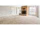 A bright living room features a brick fireplace and large windows providing natural light at 3855 S Monaco St # 166, Denver, CO 80237
