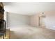 A cozy living room features a brick fireplace, neutral tones, and ample open space at 3855 S Monaco St # 166, Denver, CO 80237