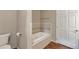 Relaxing bathroom with a deep soaking tub, tiled surround, and wood-look tile flooring for added comfort at 1038 Tenderfoot Dr, Larkspur, CO 80118