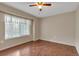 Comfortable bedroom with a bright window, wood floors, and neutral walls for a serene and peaceful ambiance at 1038 Tenderfoot Dr, Larkspur, CO 80118