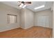 Light filled bedroom with a ceiling fan, closet, window, and laminate flooring at 1038 Tenderfoot Dr, Larkspur, CO 80118