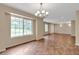 Bright and airy living room with large windows and chandelier at 1038 Tenderfoot Dr, Larkspur, CO 80118