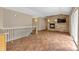 Open living room features a stone fireplace, accent wall, and wood-look tile flooring for a cozy and modern feel at 1038 Tenderfoot Dr, Larkspur, CO 80118