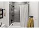 Clean bathroom with a tub, shower, and gray tile at 3116 N Gilpin St, Denver, CO 80205