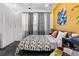 Bedroom with a mustard yellow accent wall and mid century modern decor at 3116 N Gilpin St, Denver, CO 80205