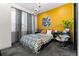 Bedroom with a mustard yellow accent wall and mid century modern decor at 3116 N Gilpin St, Denver, CO 80205