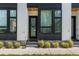 Townhouse entrance with black metal accents and landscaping at 3116 N Gilpin St, Denver, CO 80205