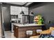 Contemporary kitchen with dark accents, an island, and modern appliances at 3116 N Gilpin St, Denver, CO 80205