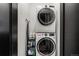 Stackable washer and dryer in a well-lit laundry closet at 3116 N Gilpin St, Denver, CO 80205