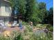 Backyard features a deck with lounge chairs, greenery, and a water feature, creating a relaxing space at 1080 Ithaca Dr, Boulder, CO 80305