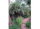 Lush backyard garden with blooming bushes, stone path, and lattice fence at 1080 Ithaca Dr, Boulder, CO 80305