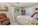 Bedroom with a comfortable bed, plush armchair, side table, and natural light from the window at 1080 Ithaca Dr, Boulder, CO 80305