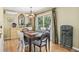 Dining room with a dark wood table, view to the backyard and stylish decor at 1080 Ithaca Dr, Boulder, CO 80305