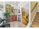 Foyer with wood door, tile floor, staircase, and artwork, showing bright, welcoming entrance at 1080 Ithaca Dr, Boulder, CO 80305