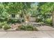 View of a home with manicured front yard and landscaping, and driveway at 1080 Ithaca Dr, Boulder, CO 80305