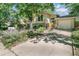 Beautiful home with a well-kept lawn, mature trees, and a concrete driveway leading to the garage at 1080 Ithaca Dr, Boulder, CO 80305