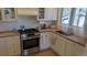 Bright kitchen boasts butcher block countertops, stainless steel appliances, and ample natural light at 1080 Ithaca Dr, Boulder, CO 80305