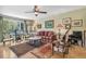 Bright living room featuring hardwood floors, a ceiling fan and multiple sitting areas at 1080 Ithaca Dr, Boulder, CO 80305
