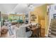 Cozy living room featuring a fireplace, large windows, and stairs with a yellow accent wall at 1080 Ithaca Dr, Boulder, CO 80305