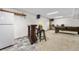 Basement bar area with built-in shelves, mini fridge, and entertainment space at 9960 Garland Ln, Broomfield, CO 80021
