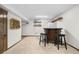 Basement bar area with custom cabinets, bar stools and beverage storage at 9960 Garland Ln, Broomfield, CO 80021