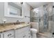 Bright bathroom with granite countertop, under sink cabinet, tile shower, and glass door at 9960 Garland Ln, Broomfield, CO 80021