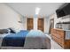 Bedroom with natural light, tv, dresser and closet access at 9960 Garland Ln, Broomfield, CO 80021