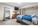 Bedroom with a large mirror, flat screen TV, and neutral color scheme for a relaxing space at 9960 Garland Ln, Broomfield, CO 80021