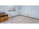 Bright bedroom featuring neutral carpet, a window, and a practical built-in storage unit at 9960 Garland Ln, Broomfield, CO 80021