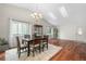 Bright dining room with skylights, wood floors, a dining table, and large windows for natural light at 9960 Garland Ln, Broomfield, CO 80021