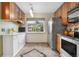 Bright kitchen features stainless steel appliances, tile flooring, ample cabinet space, and a view of the outdoors at 9960 Garland Ln, Broomfield, CO 80021