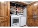 Convenient laundry room with new washer and dryer, overhead lighting and open shelving at 9960 Garland Ln, Broomfield, CO 80021