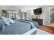 Comfortable main bedroom offers a television, wood flooring, and closet at 9960 Garland Ln, Broomfield, CO 80021
