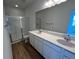 Contemporary bathroom with dual vanity, quartz counters, and glass-enclosed shower at 6601 N Netherland St, Aurora, CO 80019