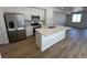 Modern kitchen with stainless steel appliances, quartz counters, and island sink at 6601 N Netherland St, Aurora, CO 80019