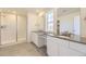 Modern bathroom with dual sinks, granite countertops, and a tiled walk-in shower at 907 Congress Pl, Elizabeth, CO 80107