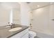 Clean bathroom with a white vanity, gray countertop, and tiled shower over tub at 907 Congress Pl, Elizabeth, CO 80107