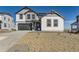 New two-story home featuring a gray and white exterior, attached garage, and rock landscaping at 907 Congress Pl, Elizabeth, CO 80107