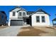 Two-story house with gray and white siding, a dark gray garage door, and a landscaped yard at 907 Congress Pl, Elizabeth, CO 80107