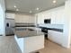 Spacious kitchen with white cabinets, gray countertops, and stainless steel appliances at 907 Congress Pl, Elizabeth, CO 80107