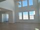 Bright living room with large windows offering scenic views and hardwood floors at 907 Congress Pl, Elizabeth, CO 80107