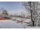 Backyard with a vibrant red fence and a blanket of snow at 4211 Miners Candle Pl, Castle Rock, CO 80109