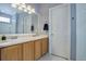 Bathroom featuring a double sink vanity, large mirror, and a clean, bright space at 4211 Miners Candle Pl, Castle Rock, CO 80109