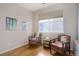 Cozy bedroom with two cushioned chairs next to a bright window at 4211 Miners Candle Pl, Castle Rock, CO 80109