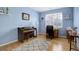 A bonus room with a piano, desk, hardwood floors, and a large window providing plenty of natural light at 4211 Miners Candle Pl, Castle Rock, CO 80109