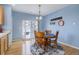 Charming dining area with round wood table, seating for four, and sliding glass doors to the outside at 4211 Miners Candle Pl, Castle Rock, CO 80109