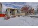 Charming single-Gathering home featuring a covered front porch and snow-covered front yard at 4211 Miners Candle Pl, Castle Rock, CO 80109