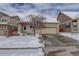 Charming single-Gathering home featuring an attached two-car garage and snow-covered front yard at 4211 Miners Candle Pl, Castle Rock, CO 80109