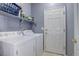 Laundry room featuring a white washer and dryer and a door at 4211 Miners Candle Pl, Castle Rock, CO 80109