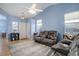 Inviting living room with vaulted ceilings, a ceiling fan, natural light, and comfortable leather seating at 4211 Miners Candle Pl, Castle Rock, CO 80109